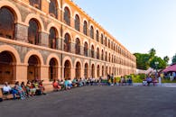 People gathered outside the historic Cellular Jail with its distinctive arched windows and barred architecture.