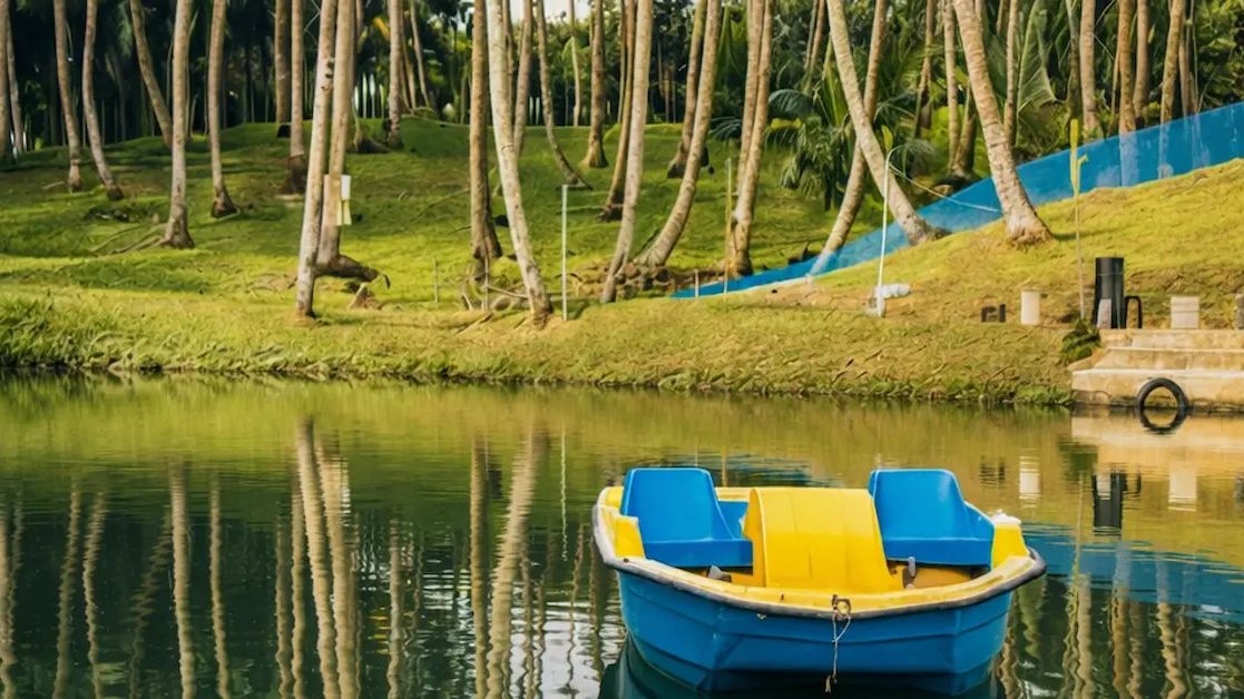 Rowboat floating on a pond surrounded by palm trees at Yellow Garden Port Blair