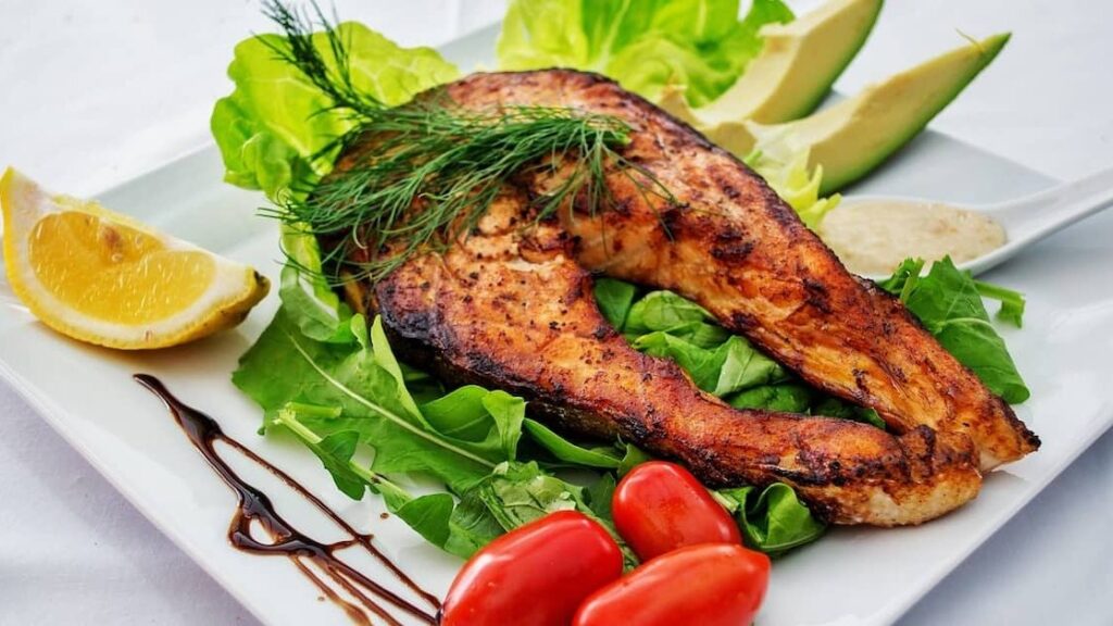Andaman grilled fish served with lettuce, lemon and avocado slices